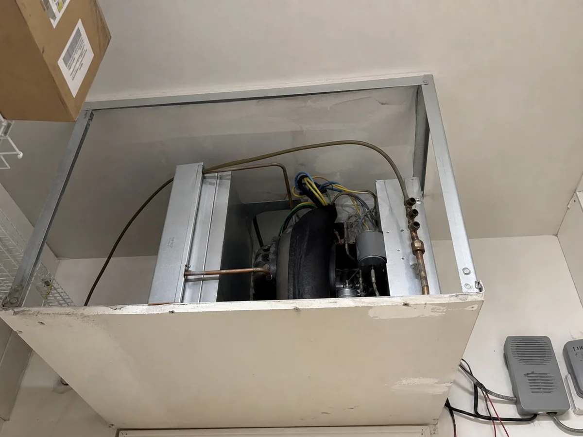 Ceiling HVAC unit opened for diagnostics